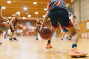 kids dribbling basketball